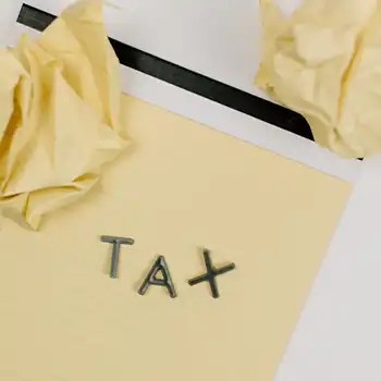 TAX letters on a yellow notepad