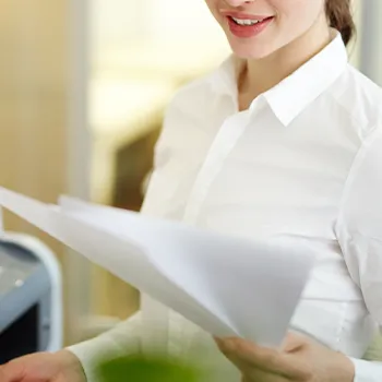 Smiling woman holding files about domestic llc