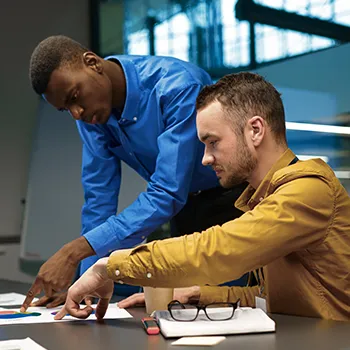 Two busy men pointing to The Benefits of Starting an LLC in Nevada