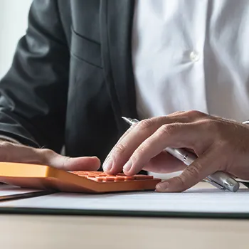 A business person using a calculator