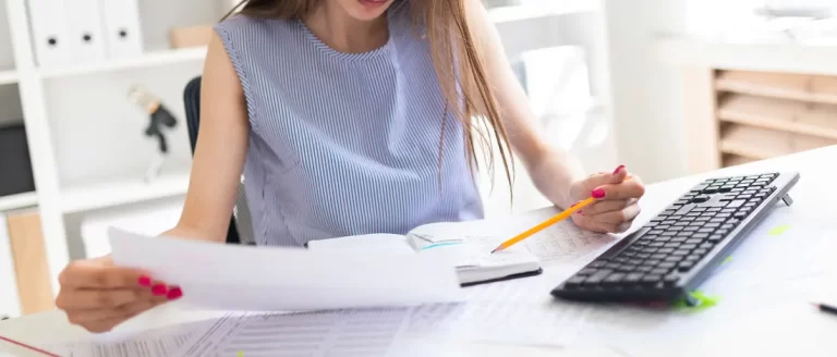 A woman busy organizing files for setting up an LLC in Colorado