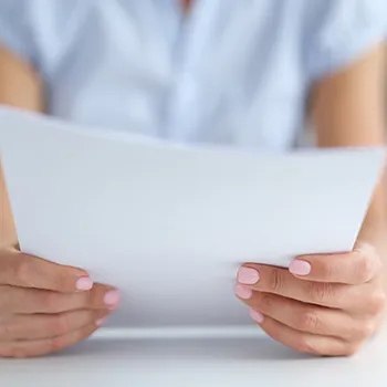 A woman holding paper