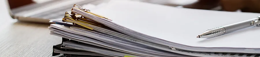 A stack of documents and files in office table