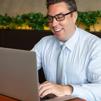 A positive man working on his laptop