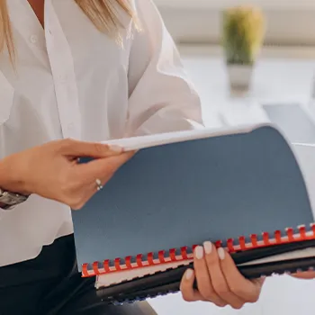 A woman opening a folder containing files