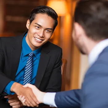 Shaking hands with another business person after creating an LLC in Arkansas