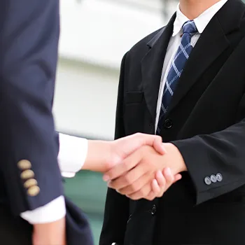 Shaking hands with another business person