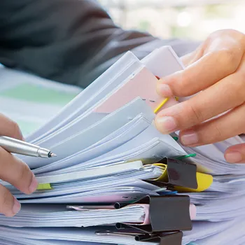 An office worker looking through clipped files