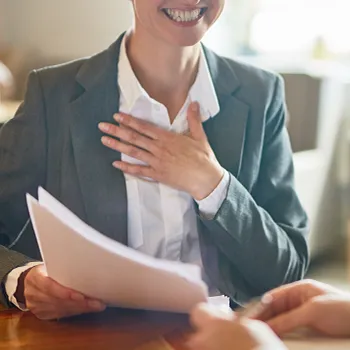 Smiling businesswoman holding documents