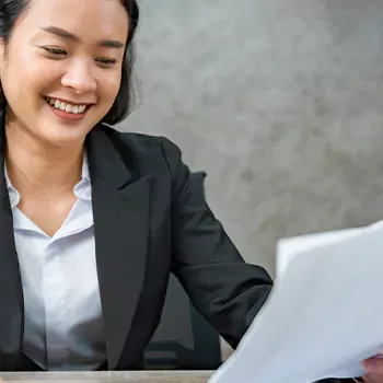 Smiling woman reading work documents