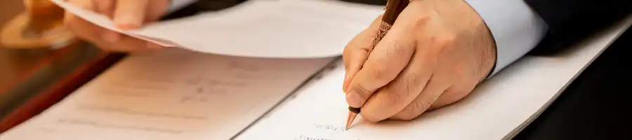 Man writing and reading documents