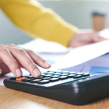 A woman calculating taxes on the table