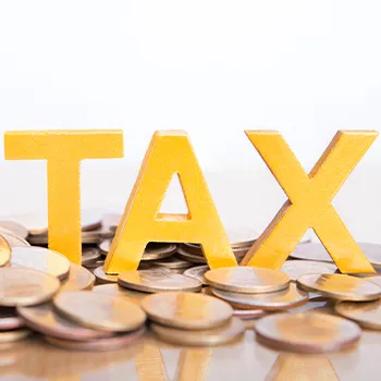 TAX letters surrounded by coins