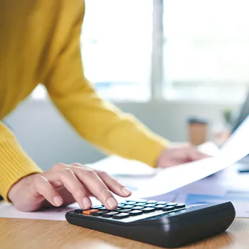 Calculating taxes wearing yellow long sleeves