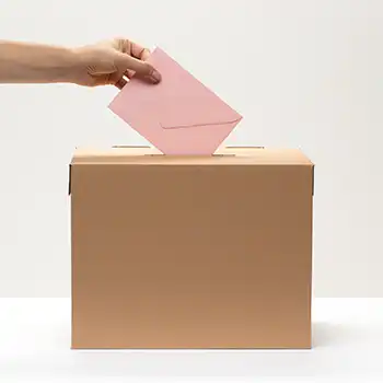 Putting a pink envelope inside a ballot box