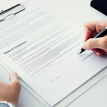 A man writing on an LLC operating agreement