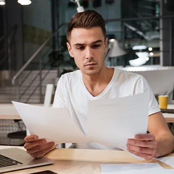 A man organizing files for creating a Limited Liability Company in California