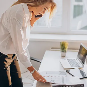 A woman organizing paperworks for an LLC business license