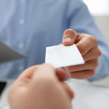 hand view of a man giving out a blank card