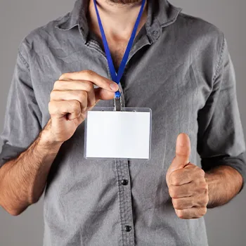 man holding out his ID and thumb up