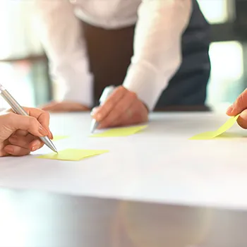 group of people writing on notes and changing llc member