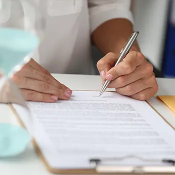 table view of a person writing on a document