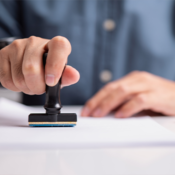 hand view of a man stamping a document