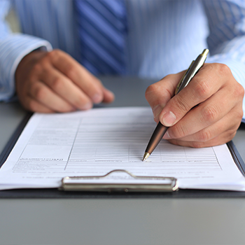 hand view of a man signing documents