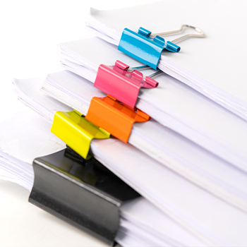 stack of documents with paper clips