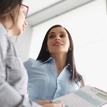 Woman holding business files while talking