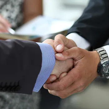 Shaking hands of two businessmen as a sign of agreement