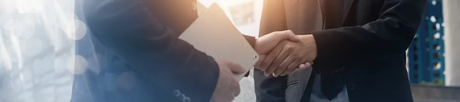 Two office workers shaking hands