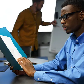 A busy person reading and analyzing a document