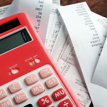 A view of a table of man calculating LLCs and taxes