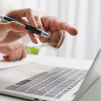 A man looking up an LLC in a laptop