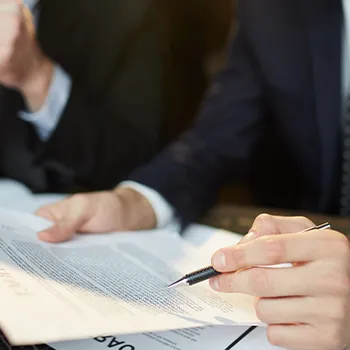 Man pointing at documents with a pen