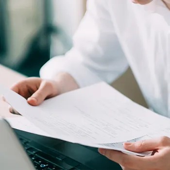 A man checking a document showing a deceased member's interest