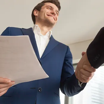 Shaking hands while holding a document