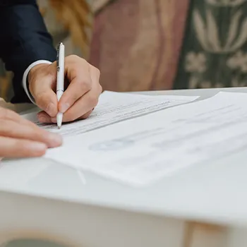 A certificate on top of a document being signed on