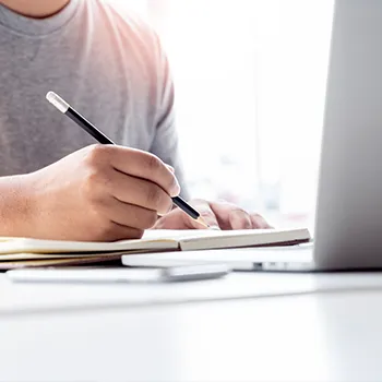 A man looking up an LLC in Virginia on laptop