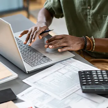 Man calculating taxes and working on tax forms