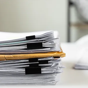 Stack of files and envelopes on a table