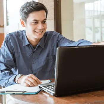 Man using laptop while having a document