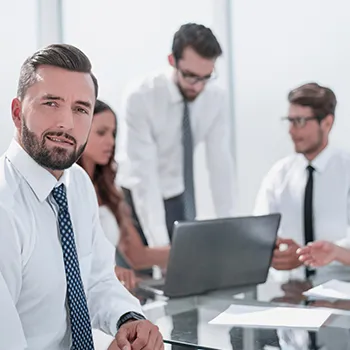 A group of members inside an office busy working