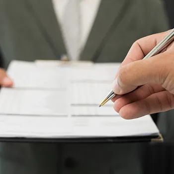 A man signing up on a paper about LLC or real estate trust