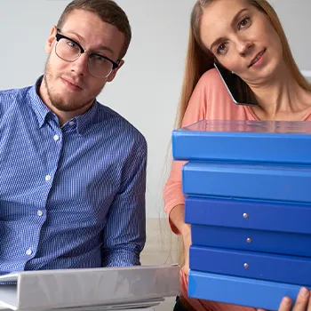 Two busy workers organizing files