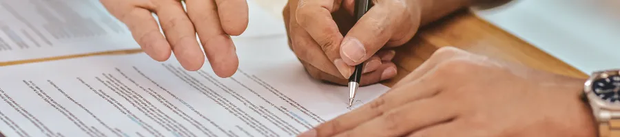 Showing someone where to sign his name