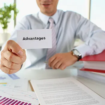 Man showing a white card in his work table