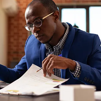 Man reading files in his work table