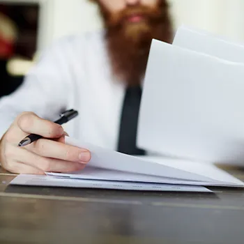 Man in white sleeves reading a document file